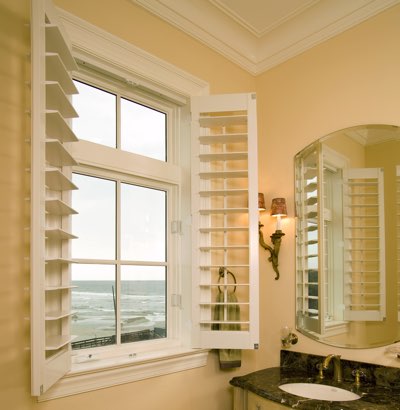 Plantation shutters in a beach house bathroom